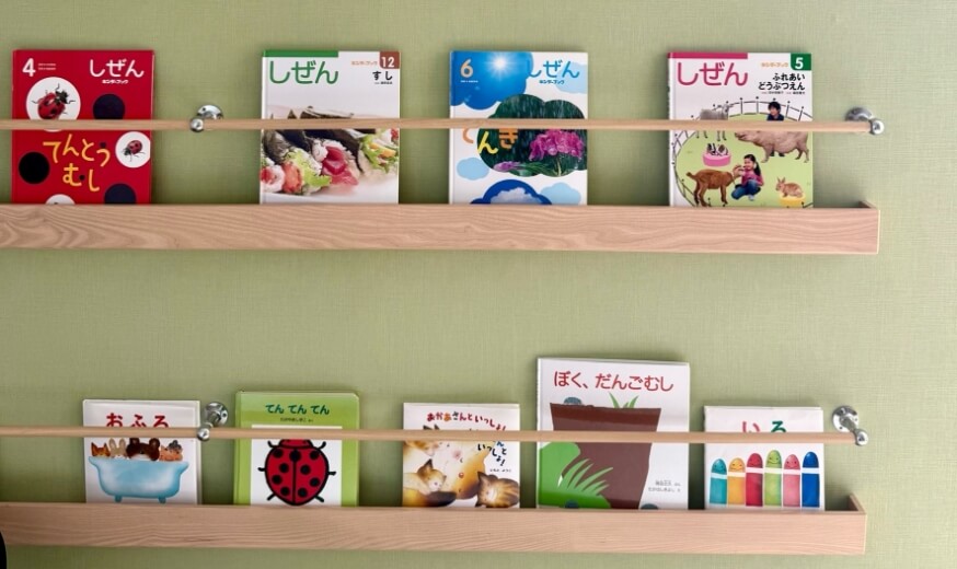 壁にかけてある棚に絵本が並んでいる